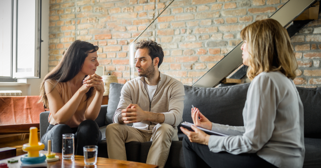 Couple in Ottawa learning to communicate openly without fear of defensive reactions with support from relationship therapist.